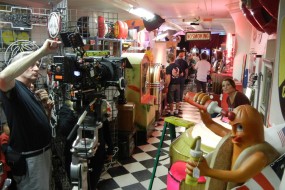 Setting Up the Camera While Extras Kill Time Playing the Slots